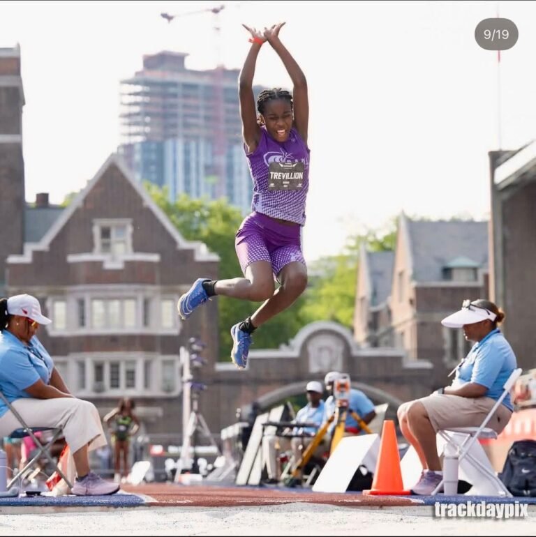 Amari Trevillion competing in the long jump at New Balance Nationals in her purple RADL uniform