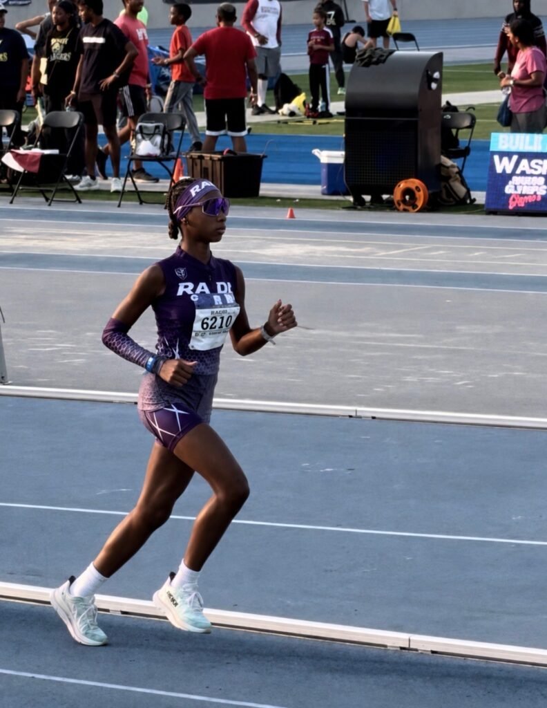 Alexa Hardy running on the track in her purple RADL uniform